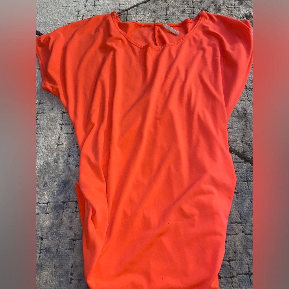 Pretty pink/coral shirt! Side of the shirt seems to be cinched!